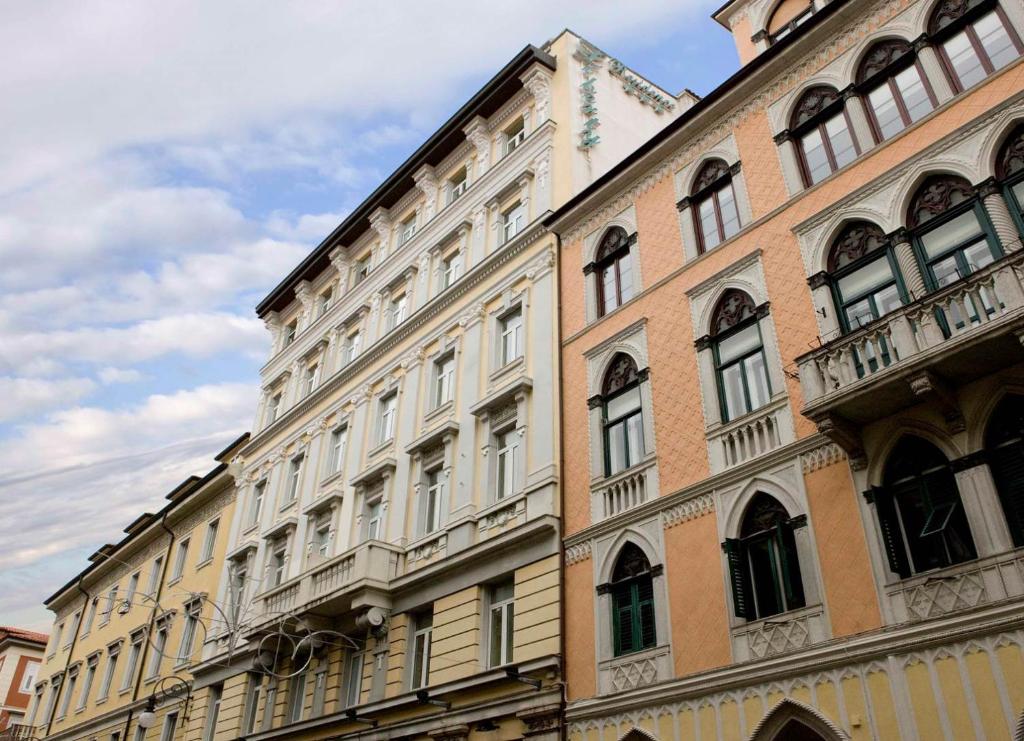 a large building with many windows on a street at Residence Liberty in Trieste