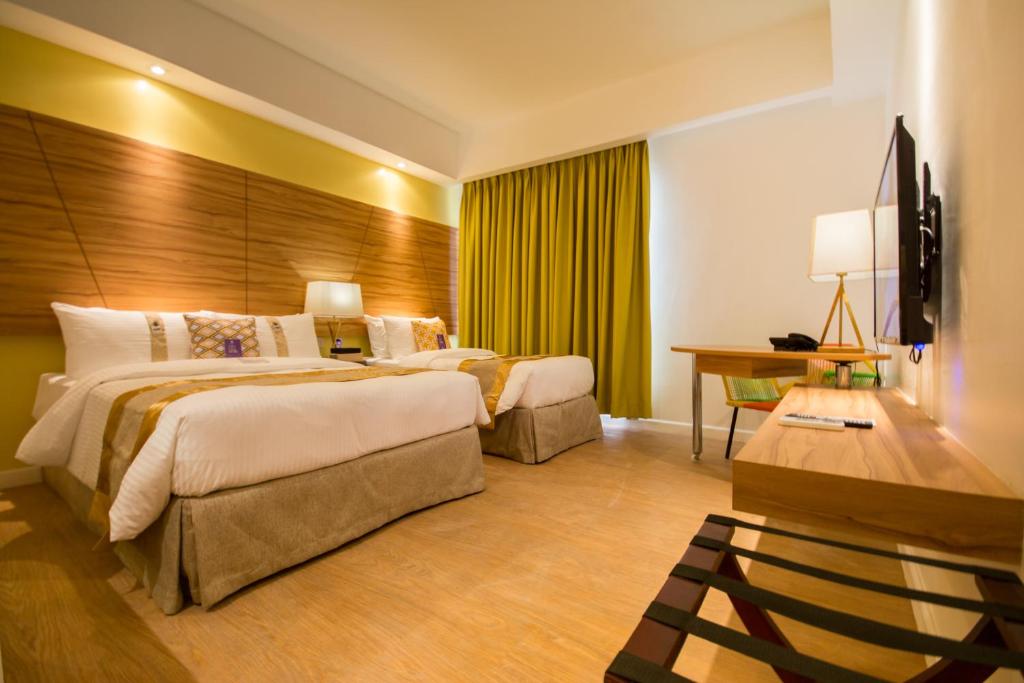 Voodi või voodid majutusasutuse Ferra Hotel and Garden Suites toas