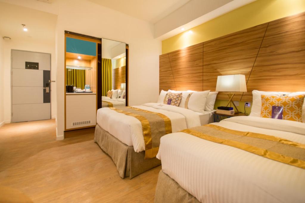 Voodi või voodid majutusasutuse Ferra Hotel and Garden Suites toas