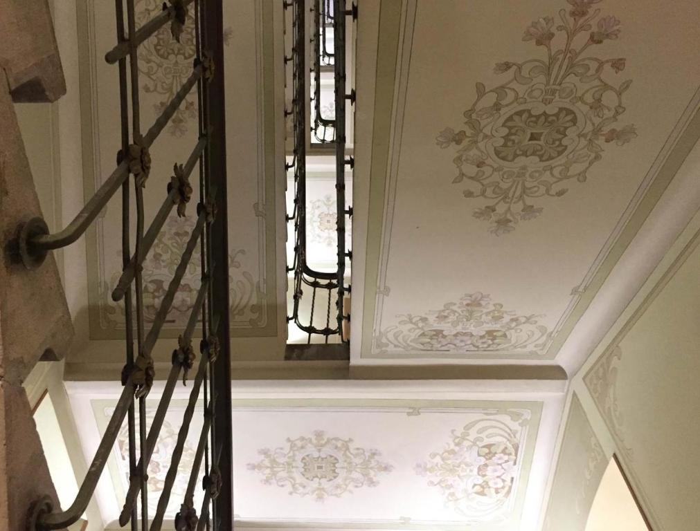 a stairwell with a patterned ceiling and a window at Residence Liberty in Trieste