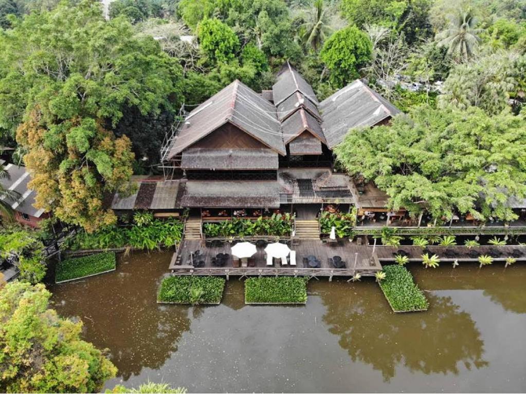 an aerial view of a house in the water at Sepilok Nature Lodge - Formerly known as Sepilok Nature Resort in Sandakan