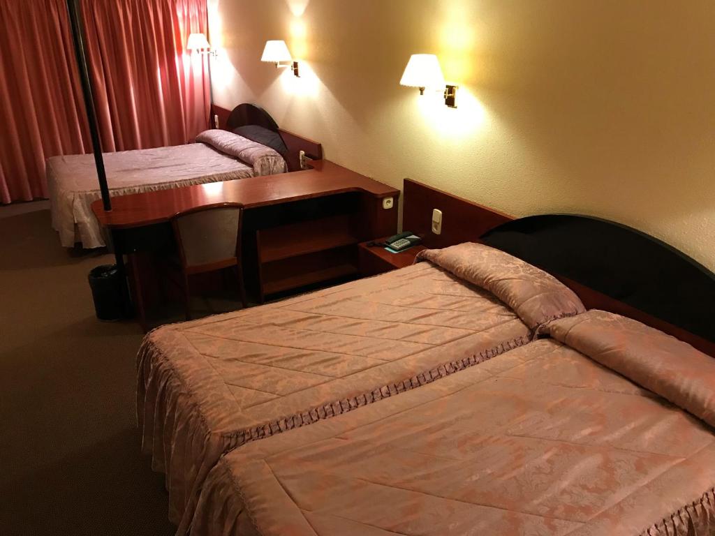 Postel nebo postele na pokoji v ubytování Hotel Roc Del Castell