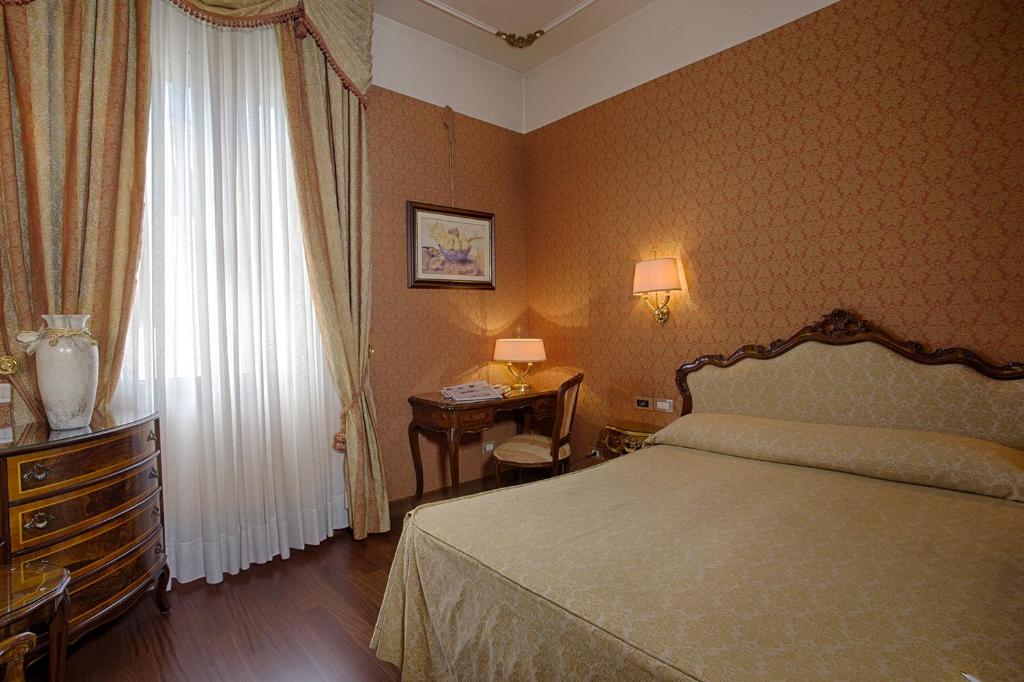 A bed or beds in a room at Locanda Vivaldi