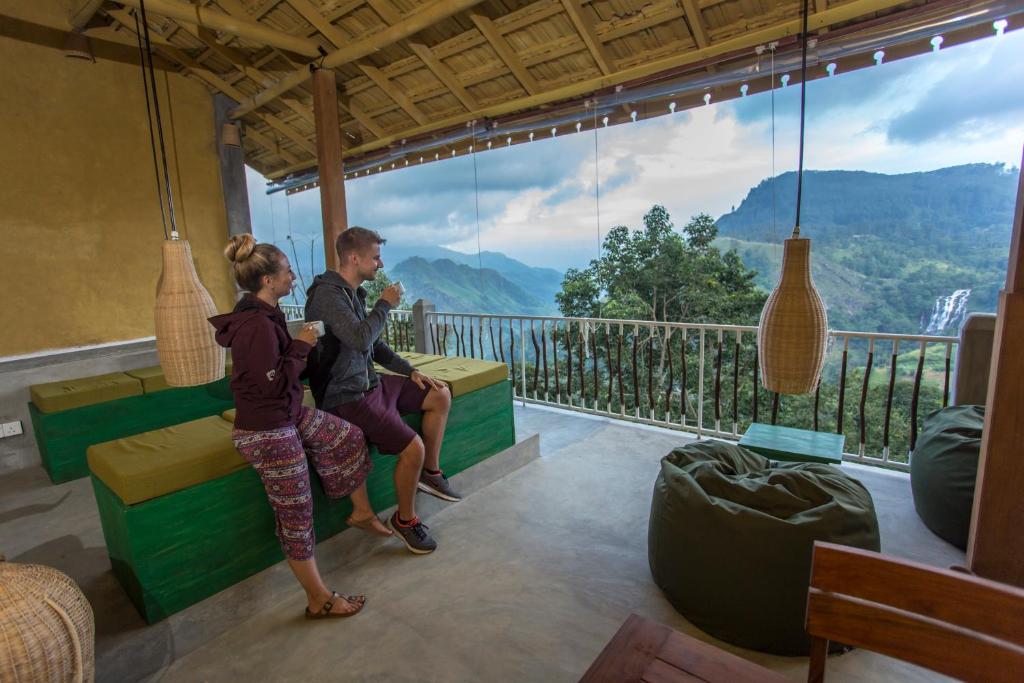 a man and a woman standing in front of a window at Serenite Ella in Ella