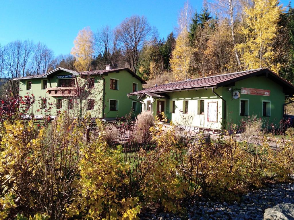 een oud huis midden in een bos bij Penzion Sněženka in Jiřetín pod Bukovou