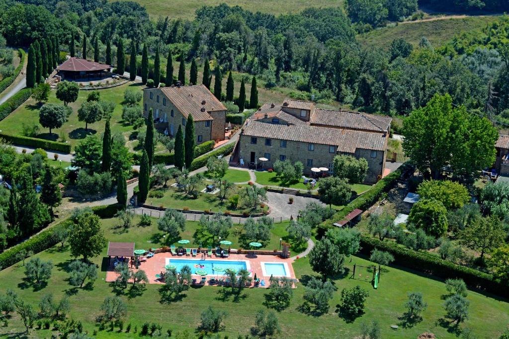 an aerial view of a house with a swimming pool at Borgo Di Collelungo in Montaione
