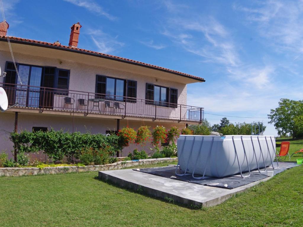 a house with a large white object in the yard at Comfortable and quiet apartment in Istria with privacy in Šajini