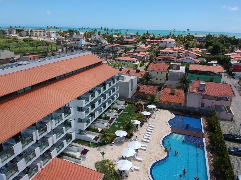 an aerial view of a resort with a swimming pool at Laguna Beach Flat in Porto De Galinhas