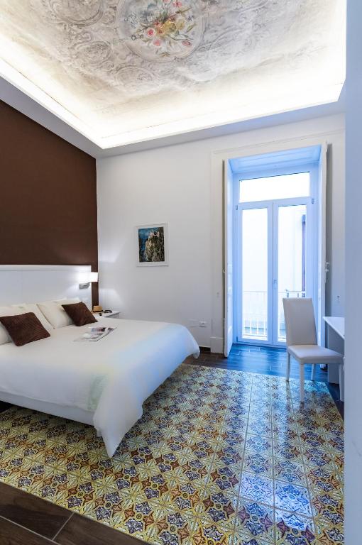 Postel nebo postele na pokoji v ubytování Suites Sorrento Elegance