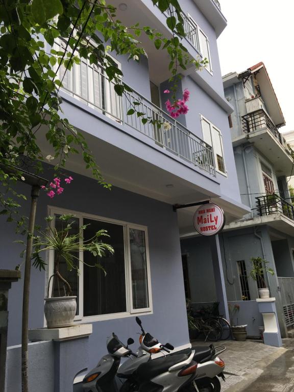 a scooter parked in front of a building at Maily Hostel in Hue