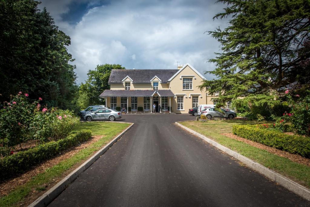 
a house with a car parked in front of it at Greenway Manor Hotel in Waterford
