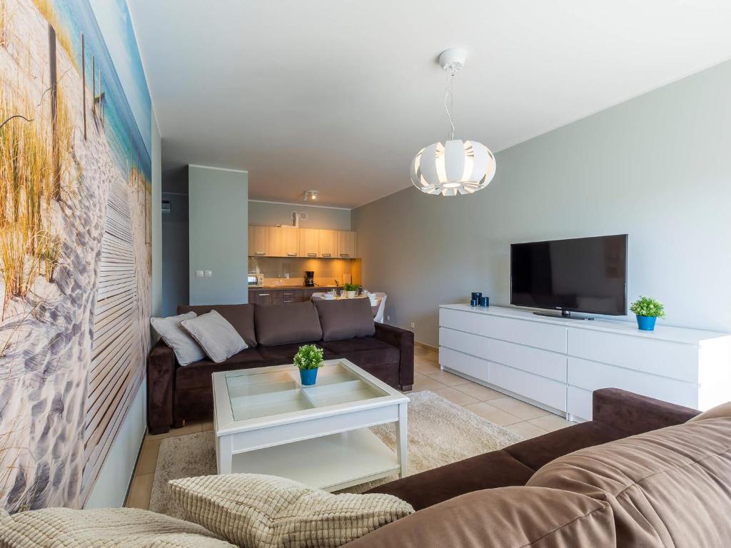 Televízia a/alebo spoločenská miestnosť v ubytovaní VacationClub - Aquarius Apartament 93