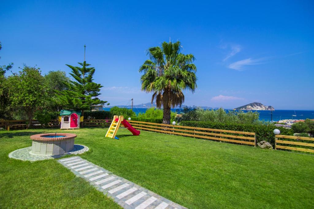 a yard with a playground with a slide at Villa Panorama in Keri