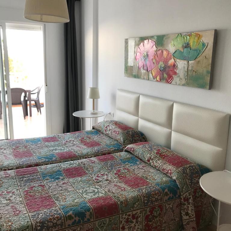 Postel nebo postele na pokoji v ubytování Hostal Tres Soles