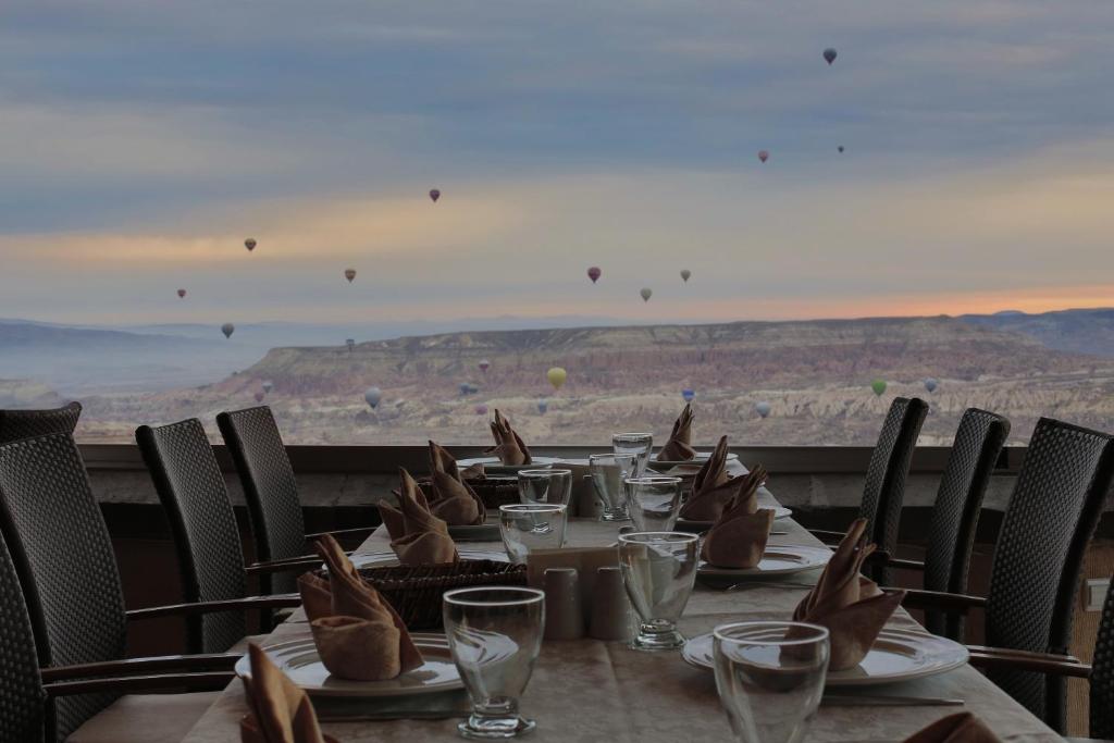 a table with a view of the grand canyon at Aden Hotel Cappadocia in Uçhisar