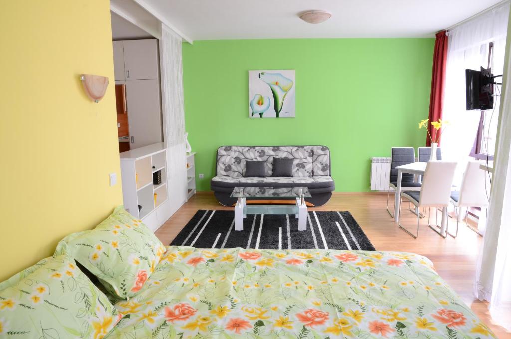 a living room with a bed and a couch at TES Flora Apartments in Borovets