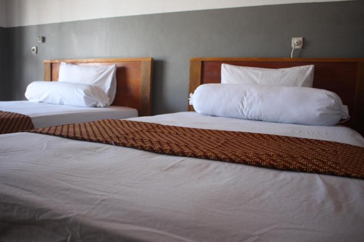 Postel nebo postele na pokoji v ubytování Ombak Homestay