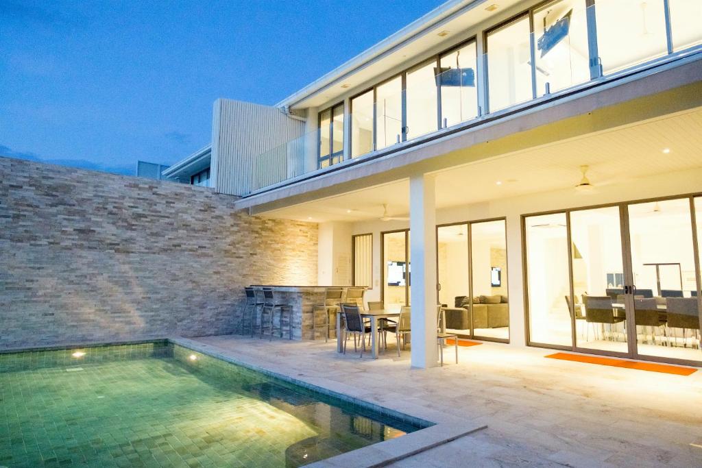 a house with a swimming pool in front of a house at Villa Oceane in Thong Son Beach