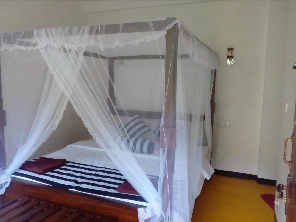 Postel nebo postele na pokoji v ubytování Forest Paddy Homestay