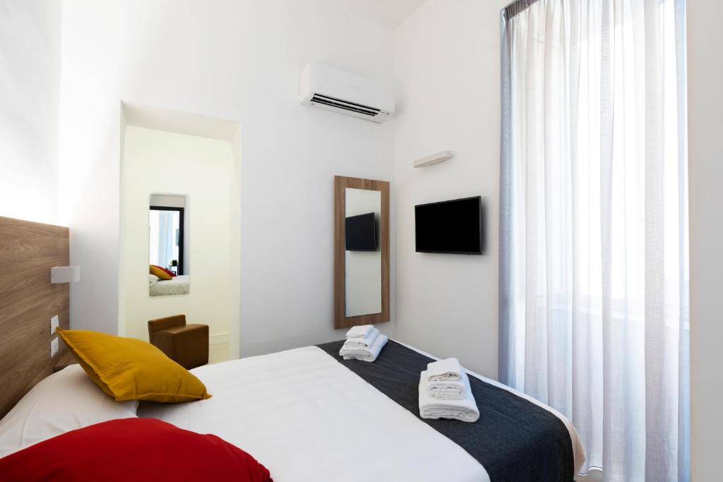a hotel room with a bed and a window at Acate81 Lifestyle Apartment in Naples