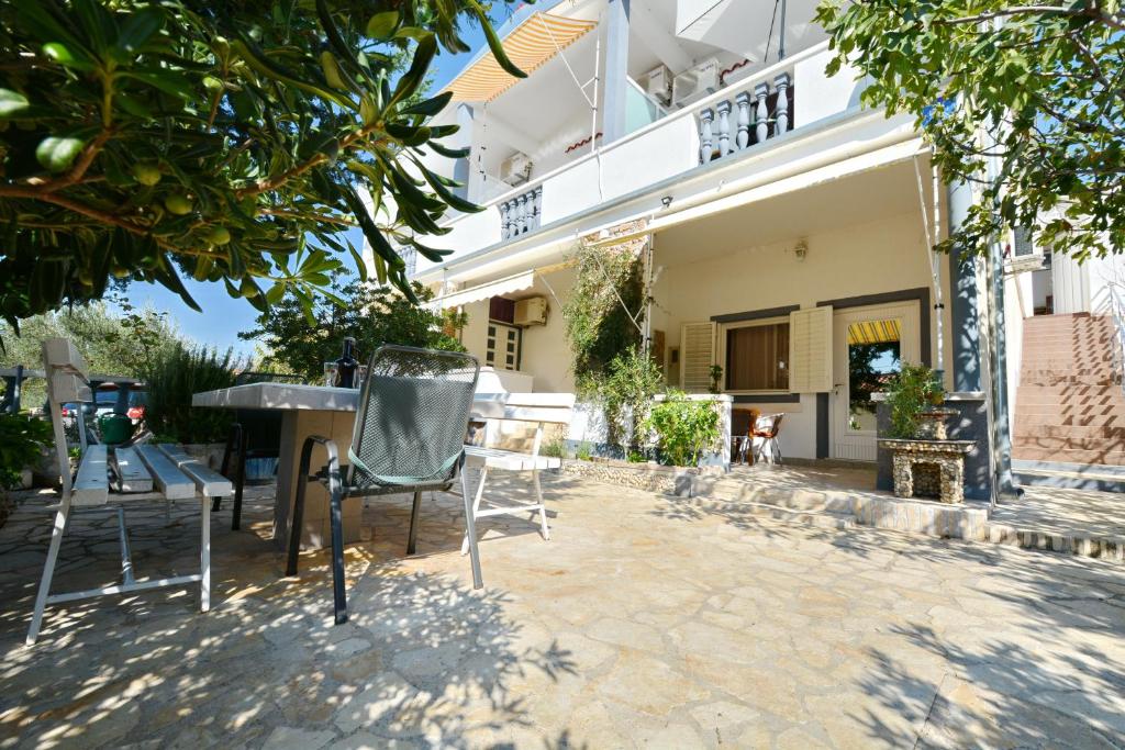 a patio of a house with a table and chairs at Aurora apartments in Starigrad