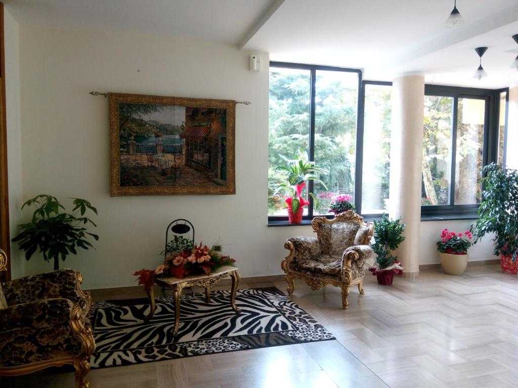 a living room with two chairs and a rug at HOTEL AL QUERCETO in Tocco Caudio