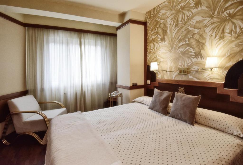 Postel nebo postele na pokoji v ubytování Hotel Maria Luisa