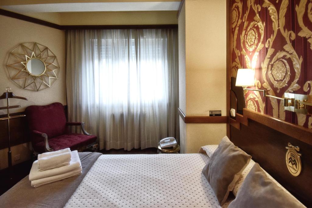 Postel nebo postele na pokoji v ubytování Hotel Maria Luisa