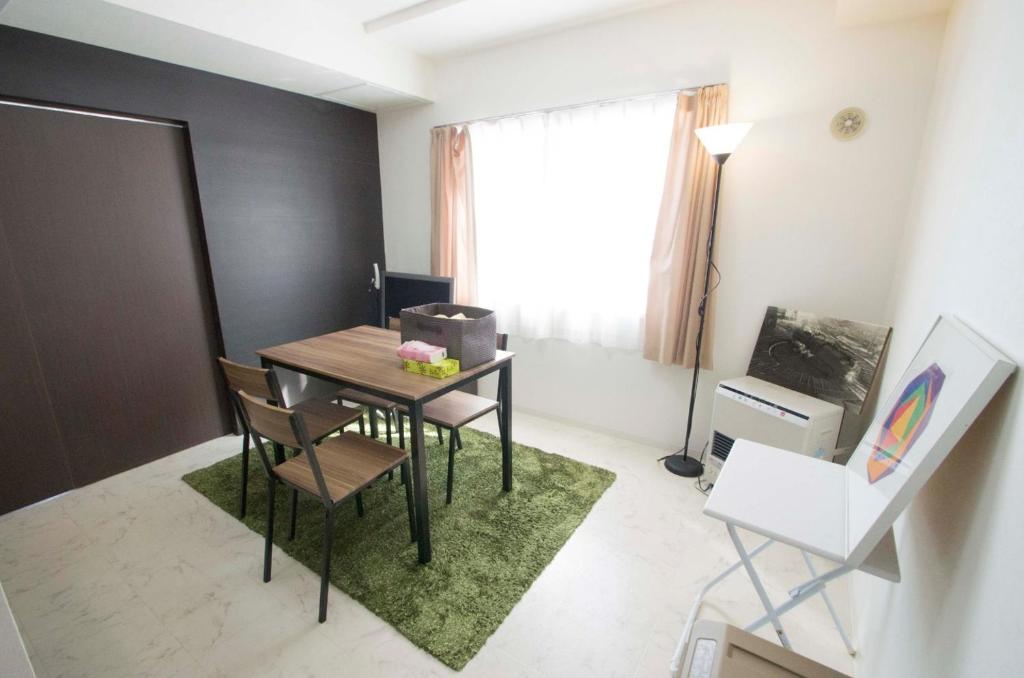 a dining room with a table and chairs and a window at Sannand / Vacation STAY 2188 in Sapporo