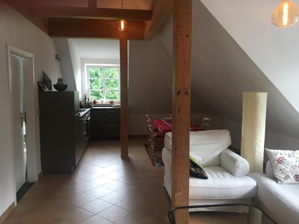 een woonkamer met een bank en een tafel bij Helle und ruhige Dachgeschosswohnung in München