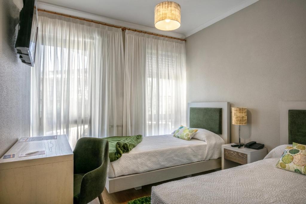 Postel nebo postele na pokoji v ubytování Residencial Clássico
