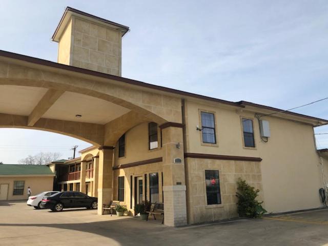 a building with a car parked in front of it at Pinn Road Inn and Suites Lackland AFB and Seaworld in San Antonio