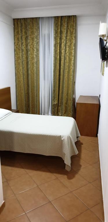 Postel nebo postele na pokoji v ubytování Grand Hotel Pavone