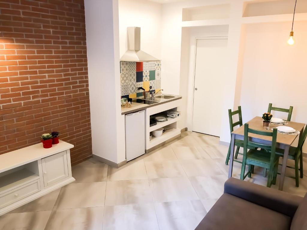a kitchen and dining room with a brick wall at Alice in Wonderland in Naples
