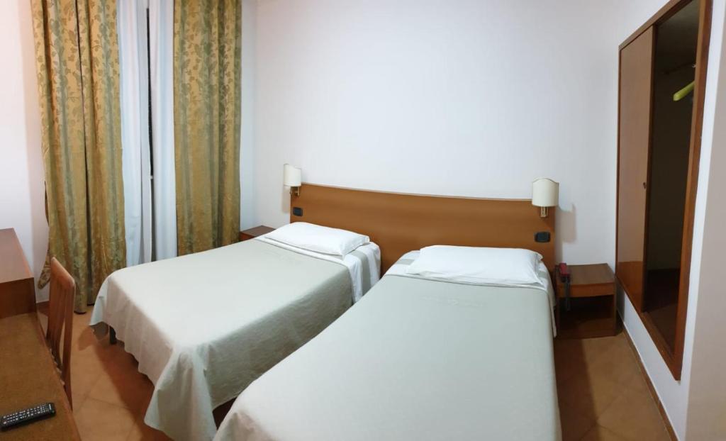 Postel nebo postele na pokoji v ubytování Grand Hotel Pavone