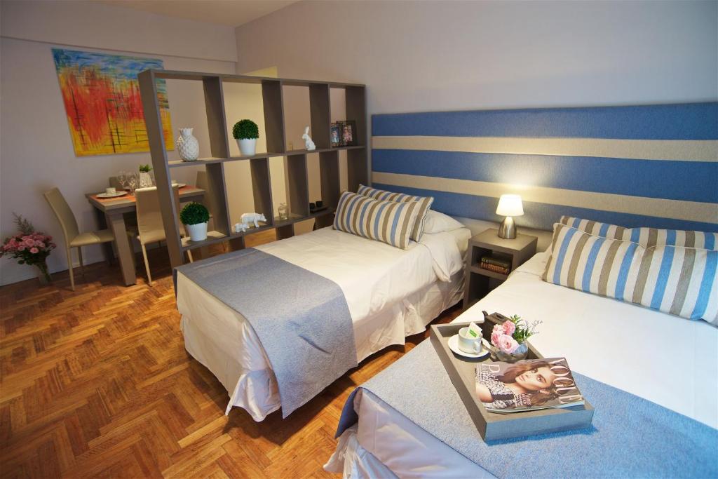 a hotel room with two beds and a table at Riobamba Street in Buenos Aires