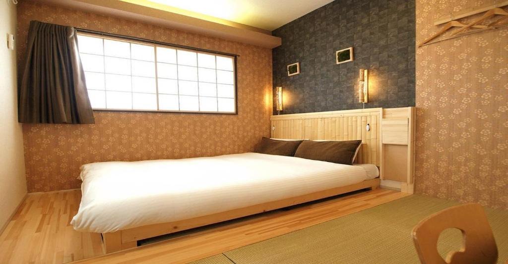 a bedroom with a large white bed with a window at 41-2 Surugamachi - Hotel / Vacation STAY 8334 in Nara