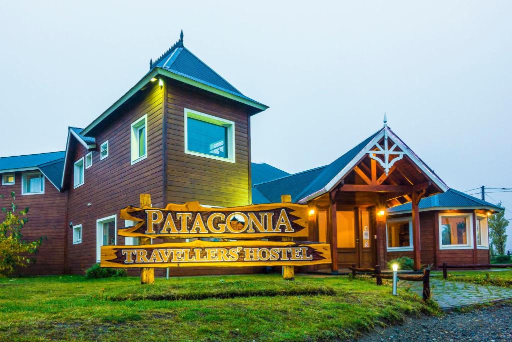 a building with a sign on the front of it at Patagonia Hostel in El Chalten