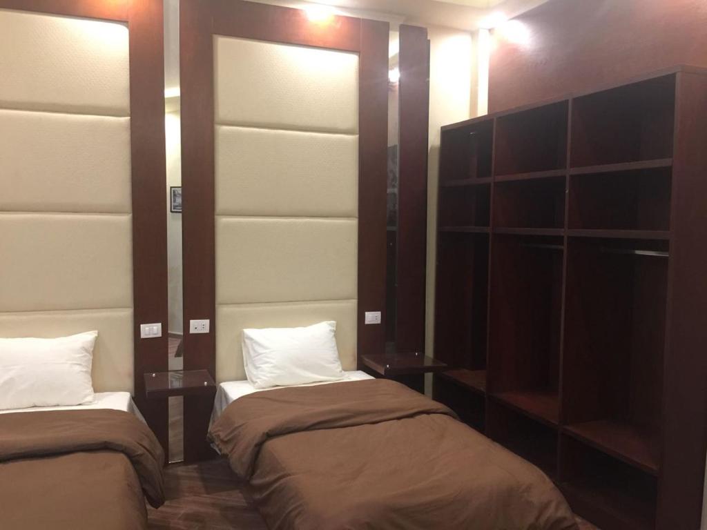Postel nebo postele na pokoji v ubytování Grand Palace Hotel