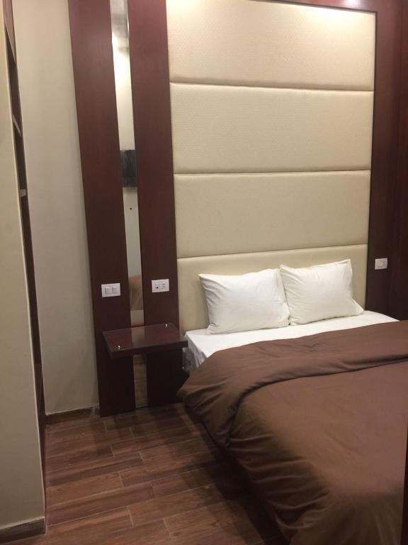 Postel nebo postele na pokoji v ubytování Grand Palace Hotel