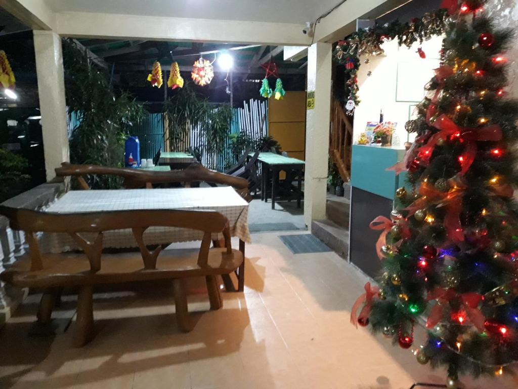 a room with a christmas tree and a table at RedDoorz Bunakidz Lodge El Nido Palawan in El Nido