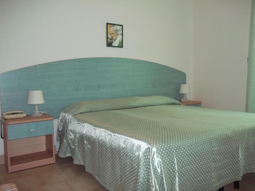 Postel nebo postele na pokoji v ubytování Hotel Rivabella