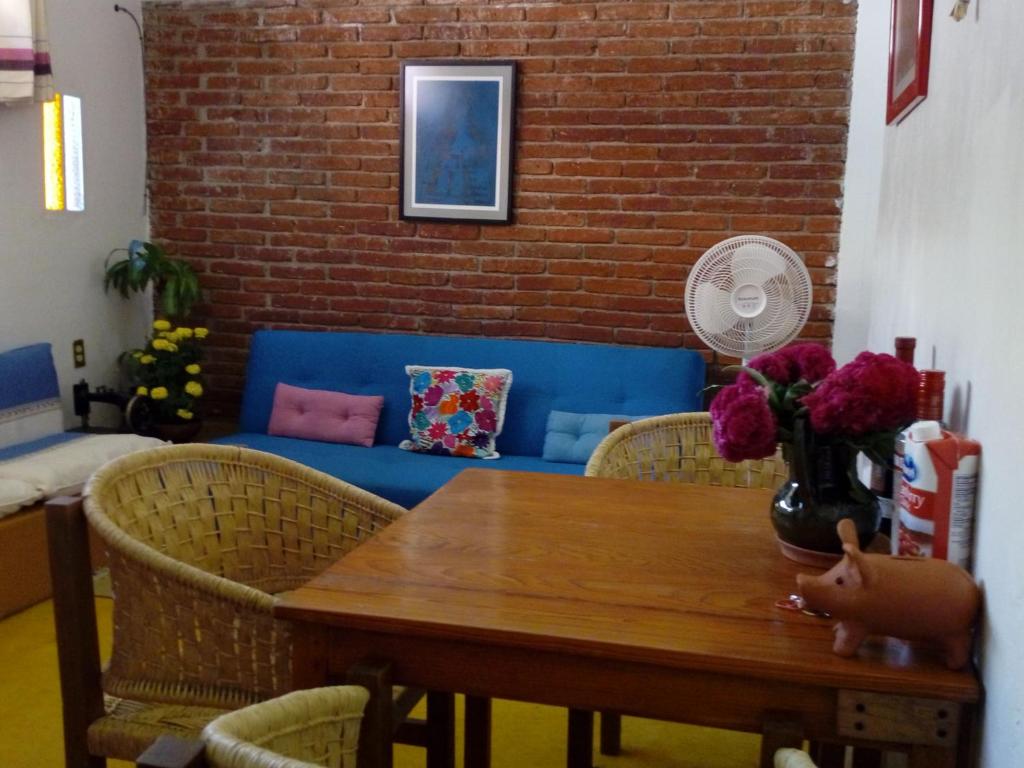 a dining room with a table and chairs and a couch at Casa Mixteca Santo Domingo Oaxaca in Oaxaca City