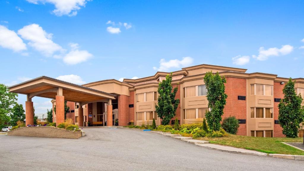 a large building with a road in front of it at Best Western Laval-Montreal & Conference Centre in Laval