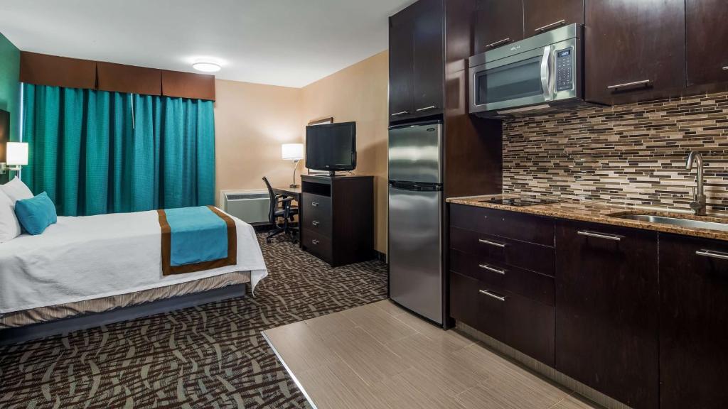 a hotel room with a bed a sink and a microwave at Best Western Plus Barrie in Barrie
