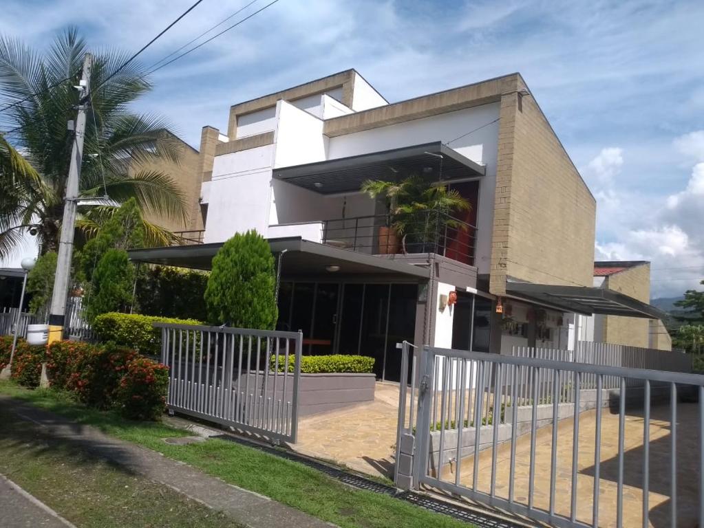 a house with a fence in front of it at Cabaña Ciudadela Premium San Jeronimo in San Jerónimo