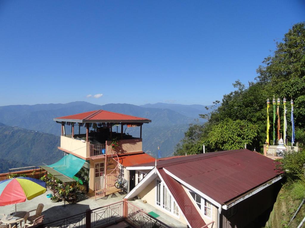 a house with a roof on top of it at Little Singamari Home Stay in Darjeeling