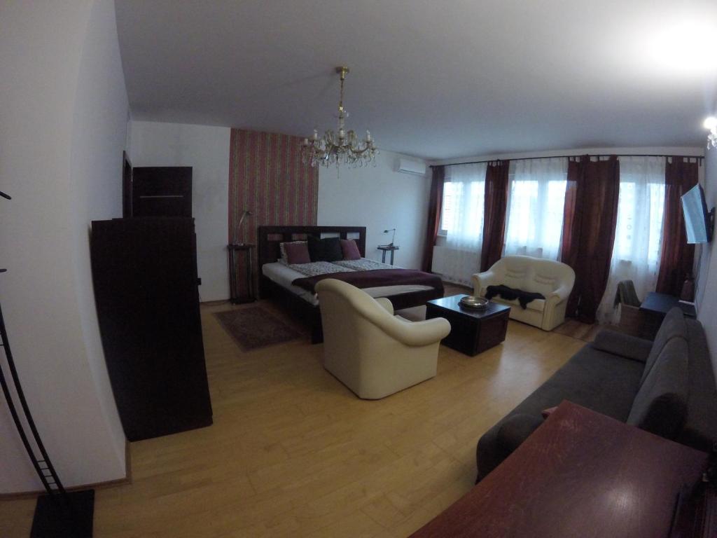 a living room with a bed and a couch at Dózsaház in Zalaegerszeg
