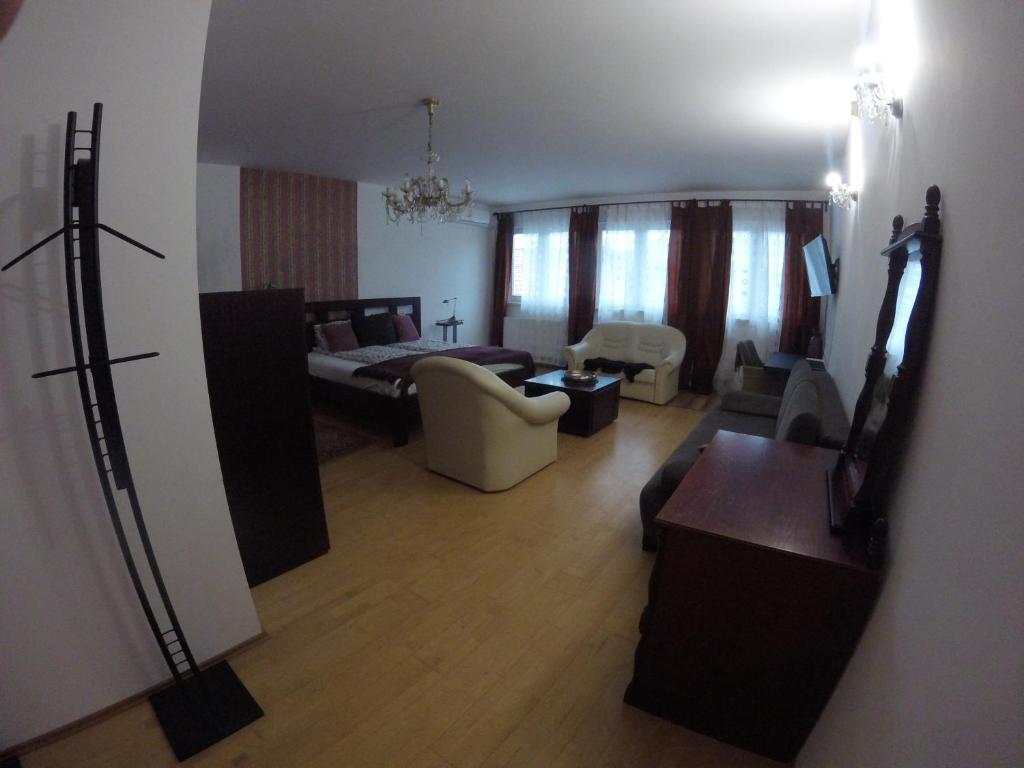 a view of a living room with a couch and a bed at Dózsaház in Zalaegerszeg