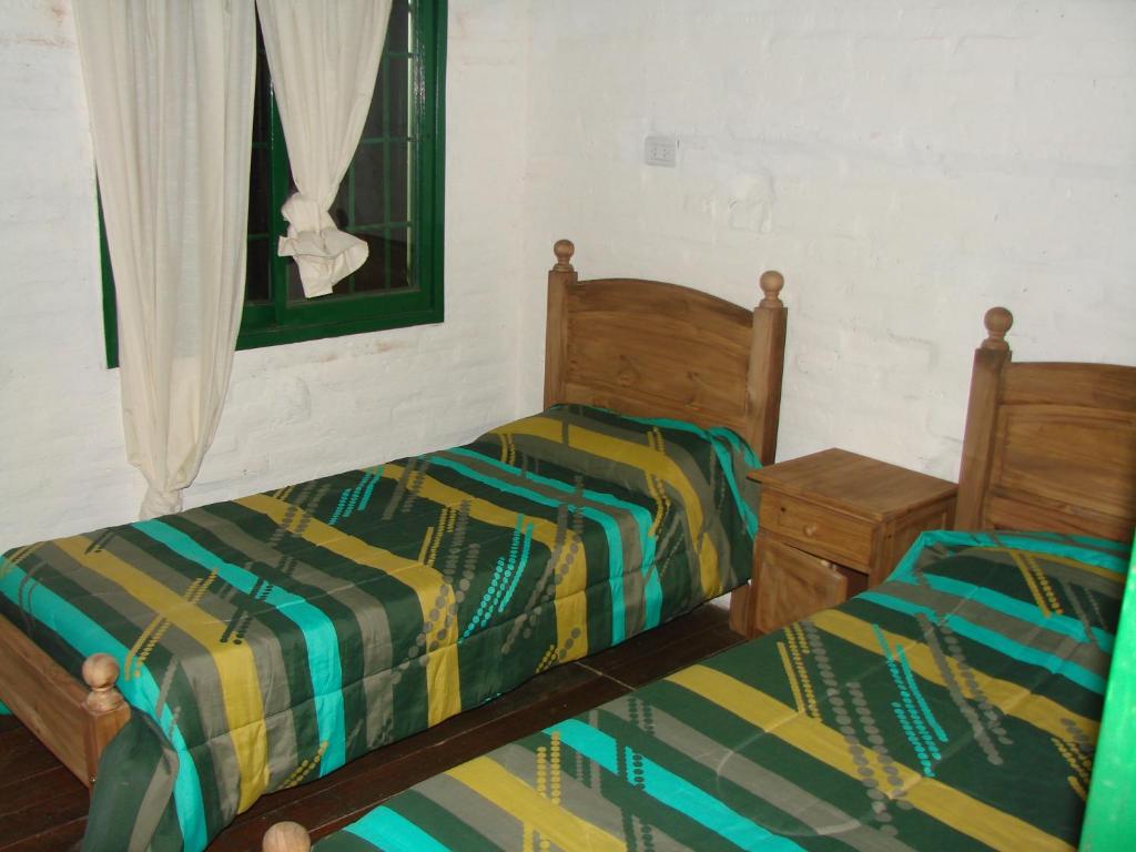 A bed or beds in a room at Cabañas las Vertientes